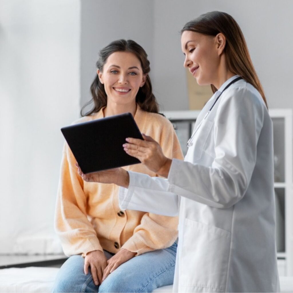 Woman meeting with a doctor to discuss surrogacy eligibility and health screening.