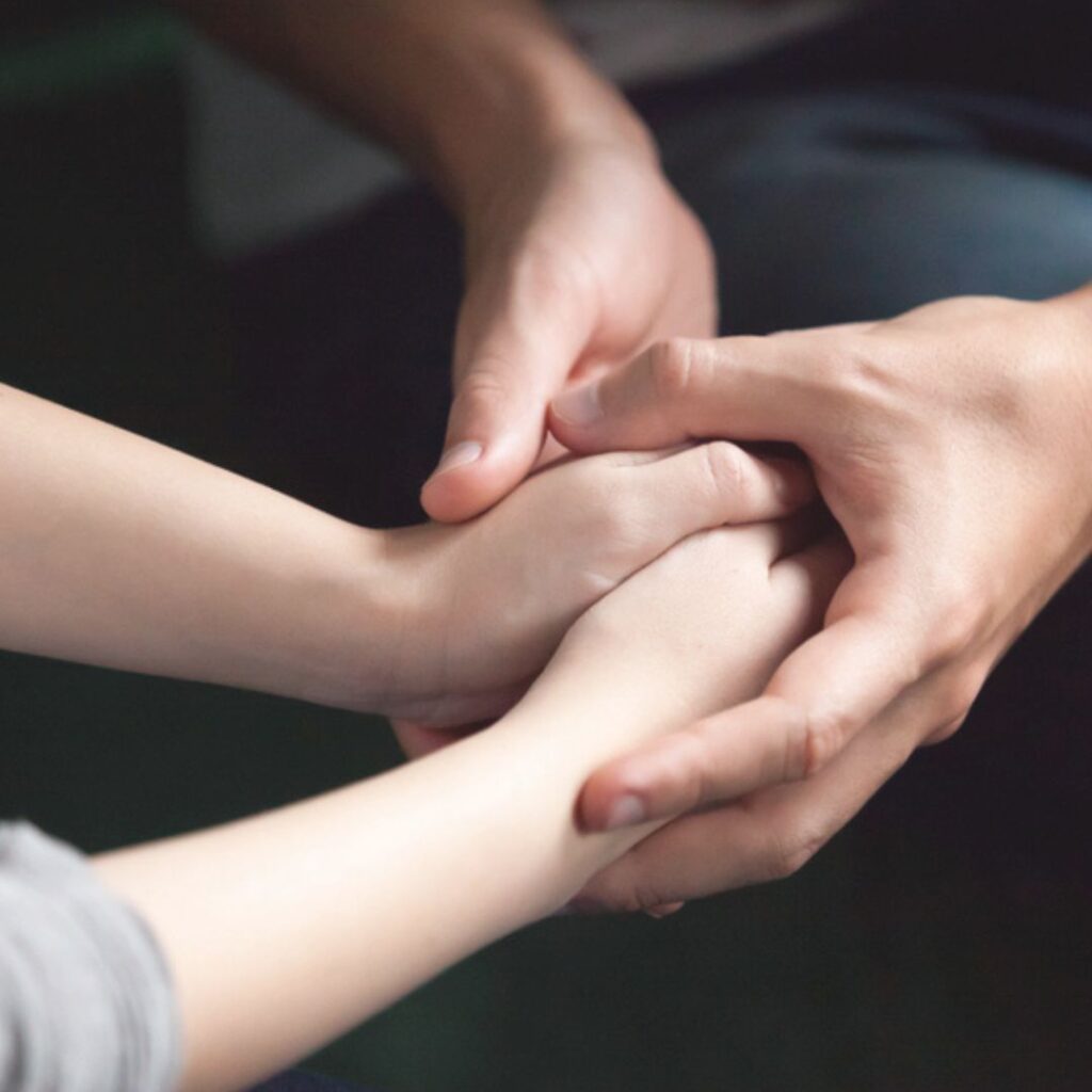 Close-up of hands symbolizing understanding and empathy for surrogates who experience pregnancy loss.