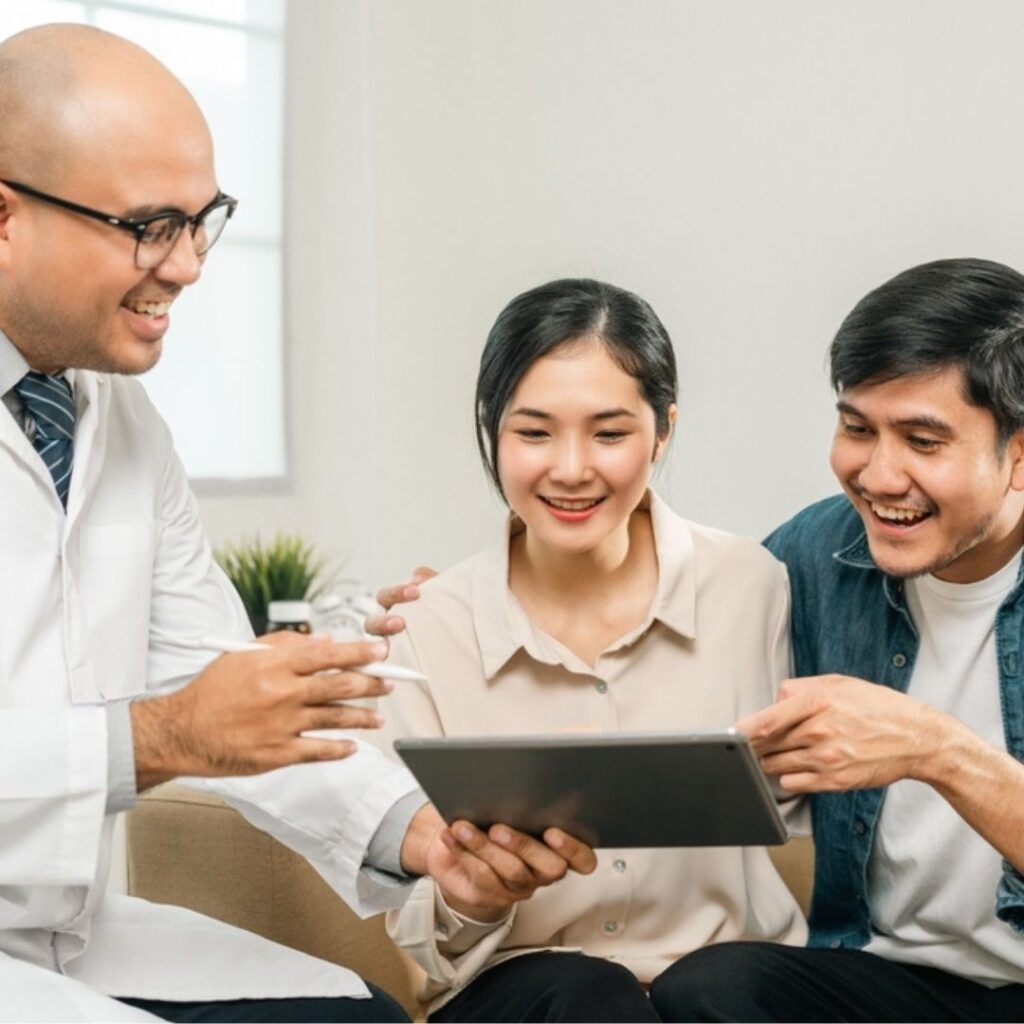 A young couple being consulted by a doctor.